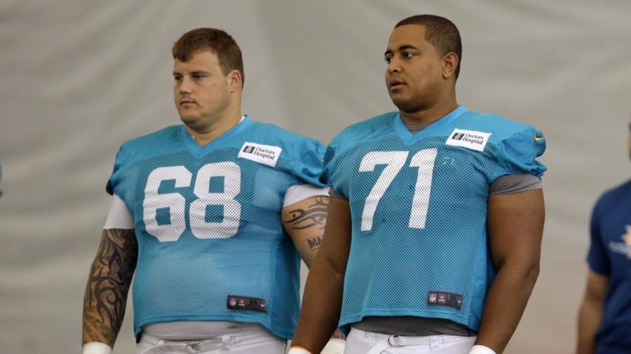 FILE - In this July 24, 2013 file photo, Miami Dolphins guard Richie Incognito (68) and tackle Jonathan Martin (71) stand on the field during an NFL football practice in Davie, Fla. Two people familiar with the situation say suspended Dolphins guard Incognito sent text messages to teammate Jonathan Martin that were racist and threatening. The people spoke to The Associated Press on condition of anonymity because the Dolphins and NFL havent disclosed the nature of the misconduct that led to Incognitos suspension. Martin remained absent from practice Monday, Nov. 4, 2013, one week after he suddenly left the team.  (AP Photo/Lynne Sladky, File)
