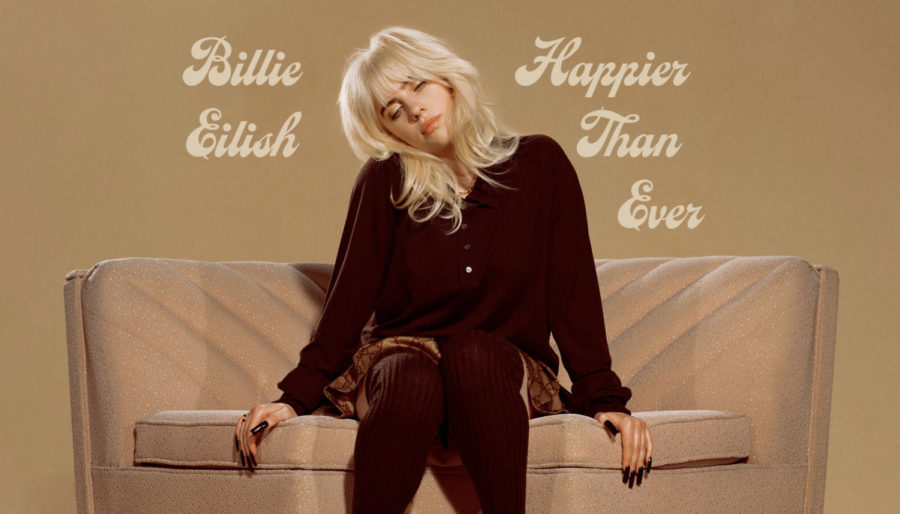 Billie Eilishs burgundy outfit pops against a beige background and seat in a promo photo for her newest album. Photo taken from online sources.