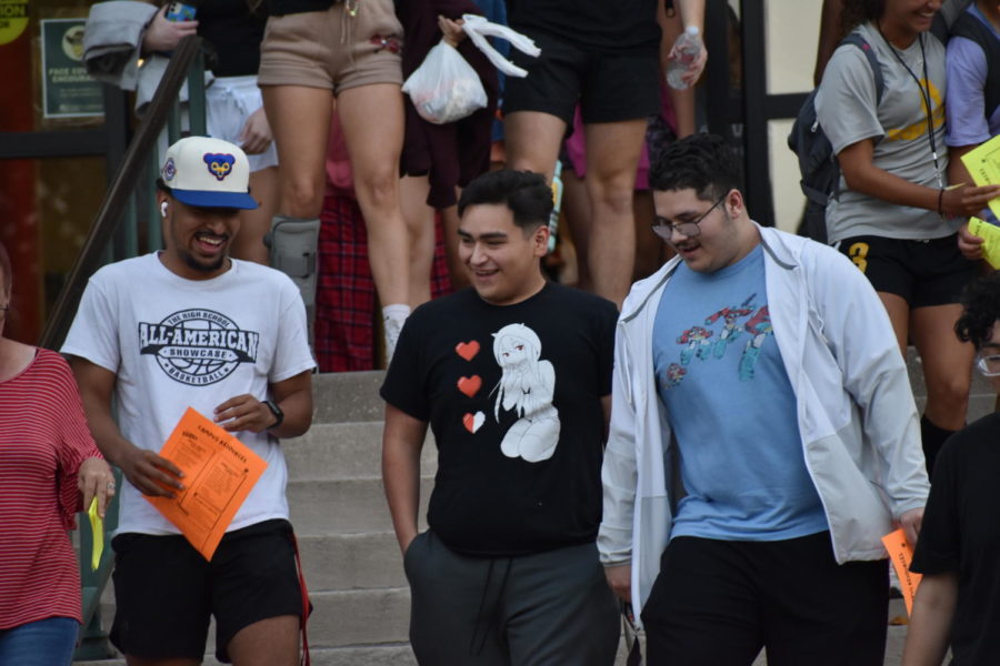 A crowd of freshmen walk down the stairs of Troutt Hall after being released from their evening Freshman Seminar class.