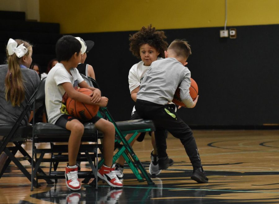 Ayzden Matthews attempts to beat another player to the last chair in the basketball-styled version of musical chairs.
