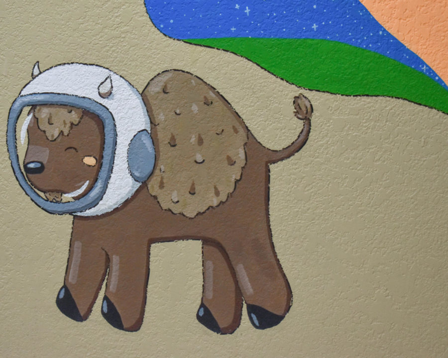 Abigail Busters new space-themed mural in Canning Hall features many symbols, such as ASL signs, well-known Oklahoma wildlife, friendly astronauts, and other personal icons.