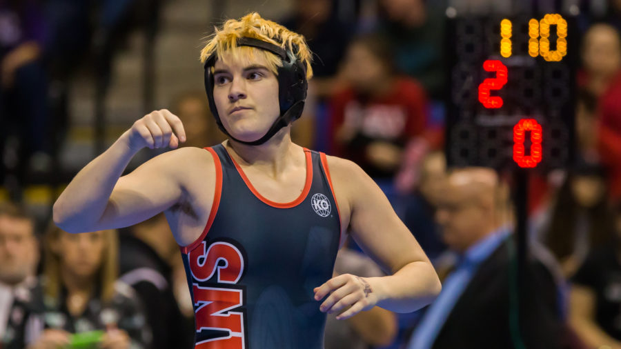 Trinity High School junior Mack Beggs waits for a signal from the referee in the final round of the 6A Girls 110 Weight Class match during the Texas Wrestling State Tournament on Saturday in Cypress, Texas. Beggs, a transgender boy, is required by state policy to compete against girls.