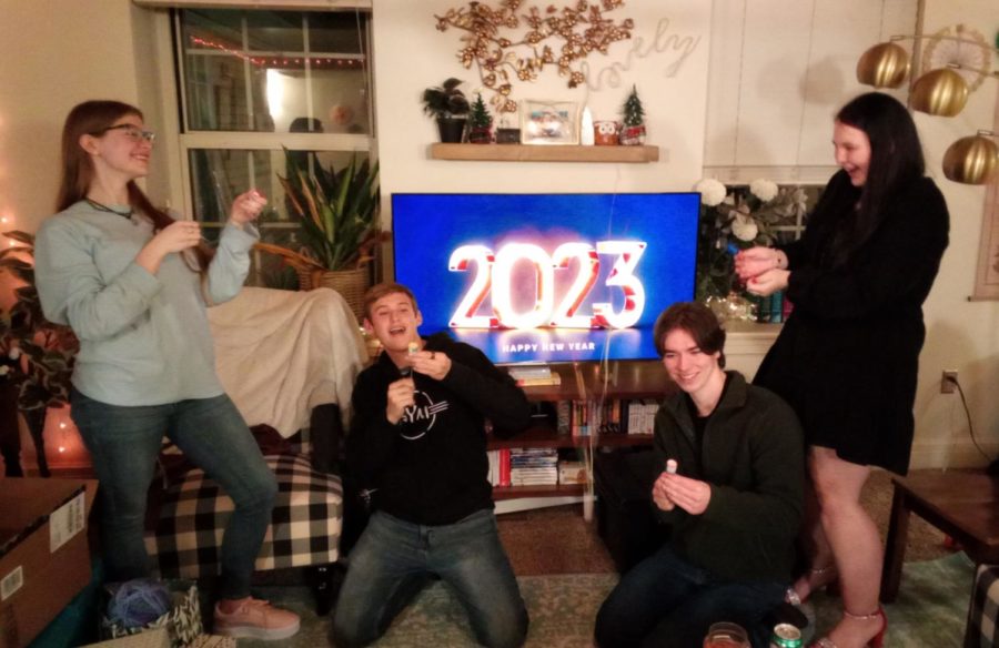 Rachael Jonas, Clay Edwards, Benjamin Huff, and Angel Tyson all celebrate the New Year by popping confetti poppers.