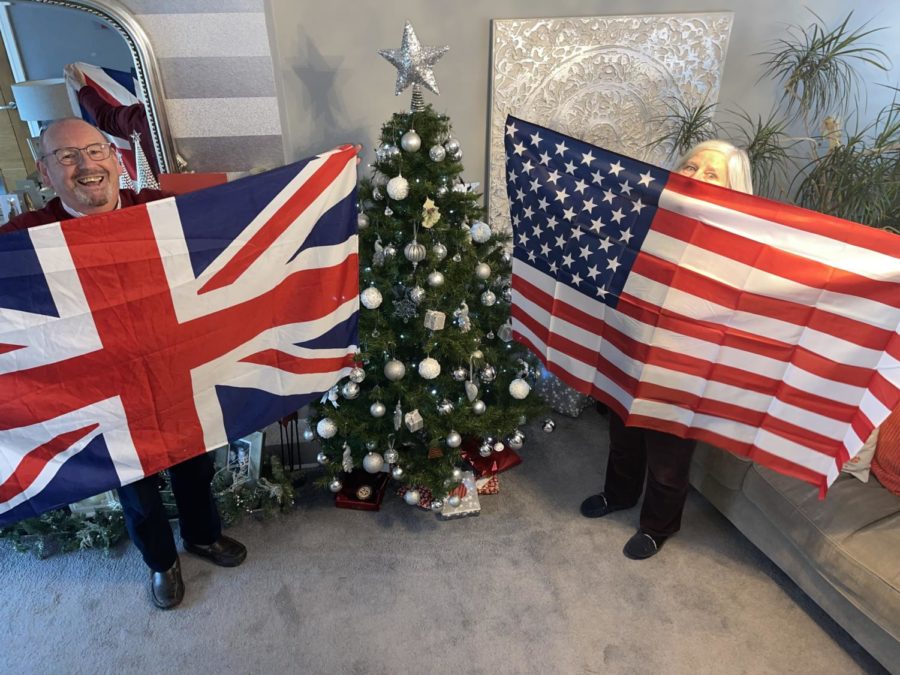 Leslie Cluskey, Harrys grandfather, holds a UK flag while Susan Cluskey, Harrys grandmother, holds a USA flag with a traditional Christmas tree in the background.