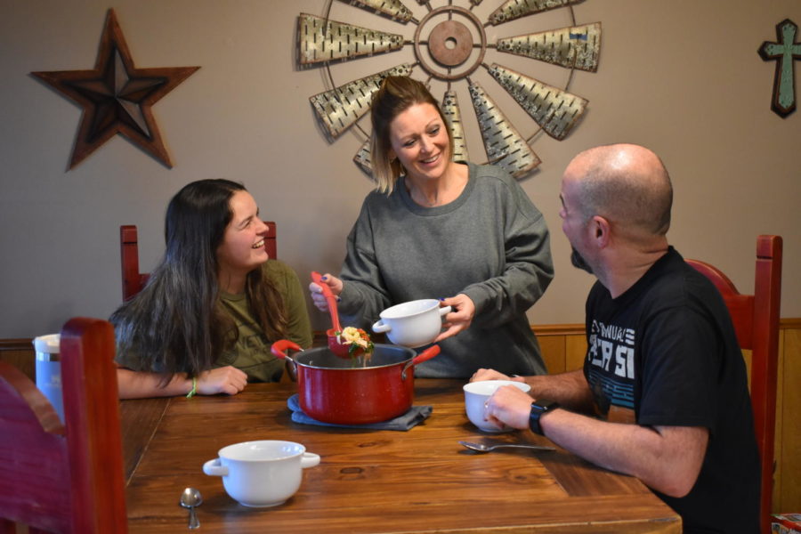 The Loughridge family, including Ryan, Shanna, and Emily, enjoy a meal together. Many families have different New Years traditions including food.