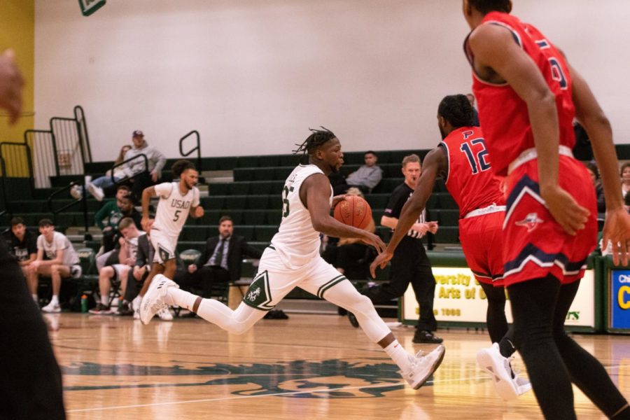 Senior Samkelo Cele sprints down the court attempting to get past OPSU defenders on Thursday night.