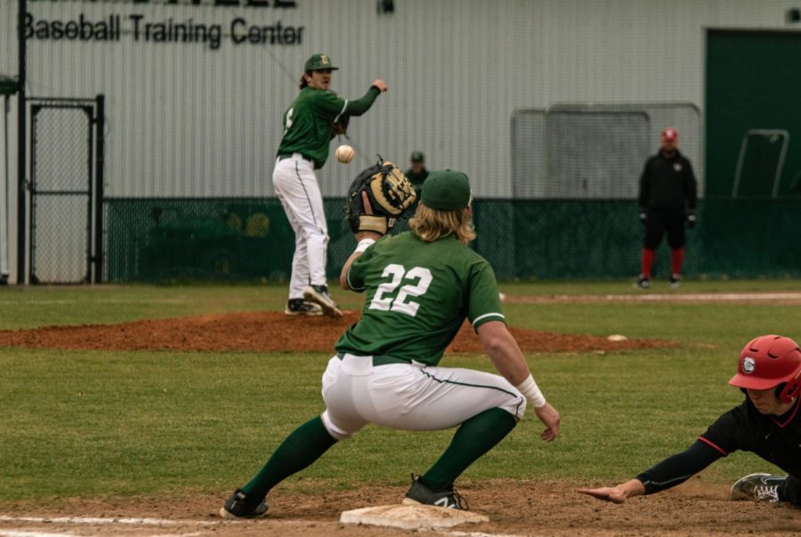 Pitcher, Boone Lasater attempts to pick-off the Bulldog on first base with a throw to Peyton McDowall. 