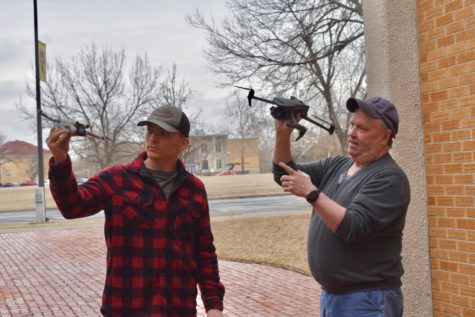 Video-production instructor David Duncan points out key features of the new drones to student Nick Fleckenstein.