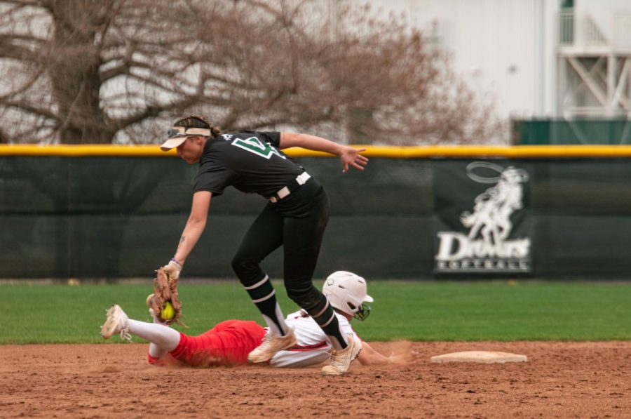 USAOs second baseman, Sierra Selfridge tags a Raven baserunner as she slides into second base. 