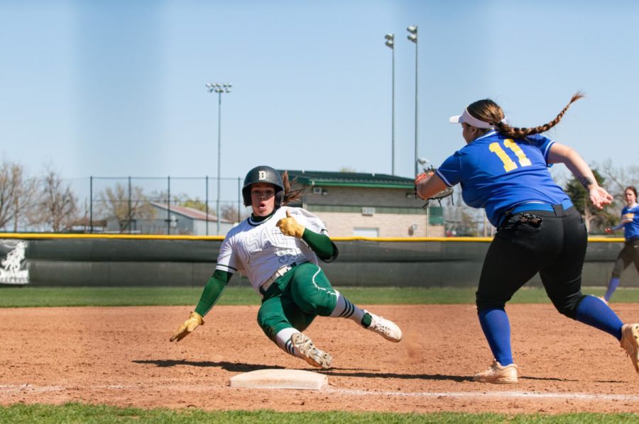 Jadyn Goucher keps her eyes on third base and she slides under the arm of CCCs third baseman. 
