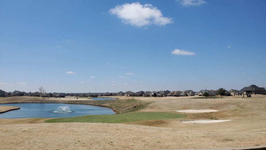The green on the 18th hole at Rose Creek Golf Club overlooks a small pond, which ten golf teams played at during the Allen B. Pease Intercollegiate Tournament in OKC. 