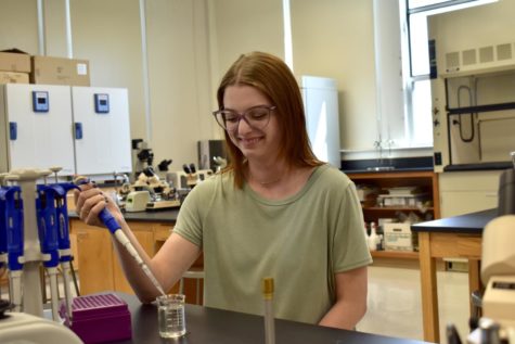 Delaney Medcalf practices using a pipette in a lab on the third floor of Austin Hall.