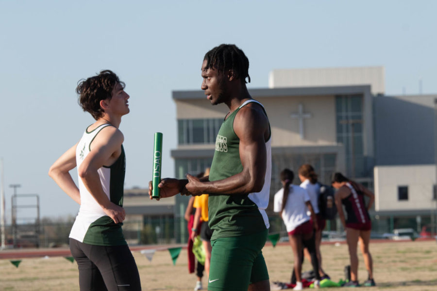Quintin+Pennells+and+Kemoy+Willis+discuss+their+event+at+an+outdoor+track+and+field+meet.+