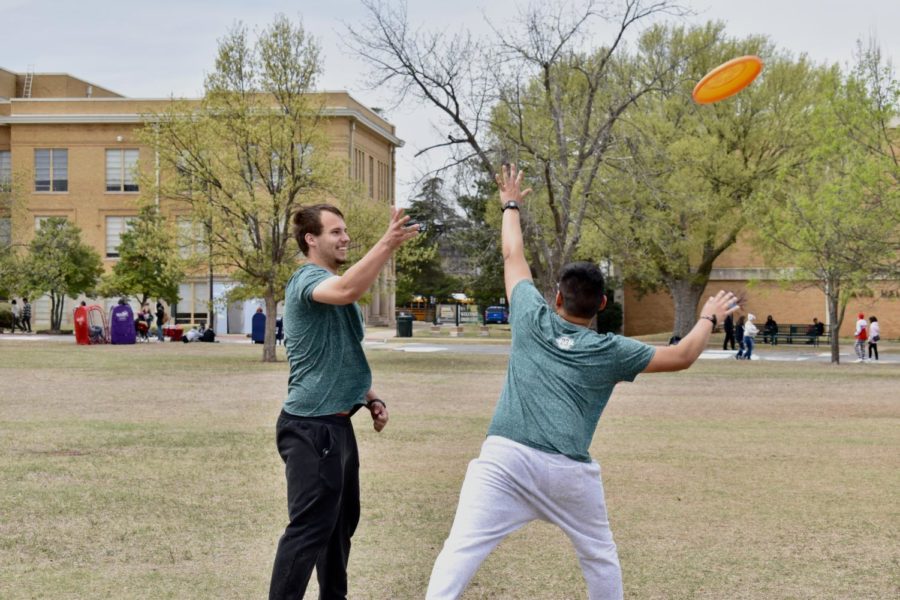 Gary Jackson attempts to throw the frisbee around Paul Tointigh during a game of Ultimate Frisbee during Droverstock.