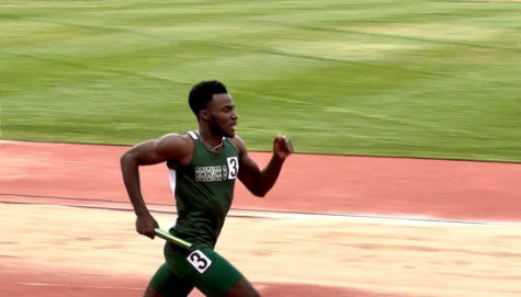 Kemoy Willis clutches the baton in his right hand during the mens 4 by 400 relay over the weekend at OU. 