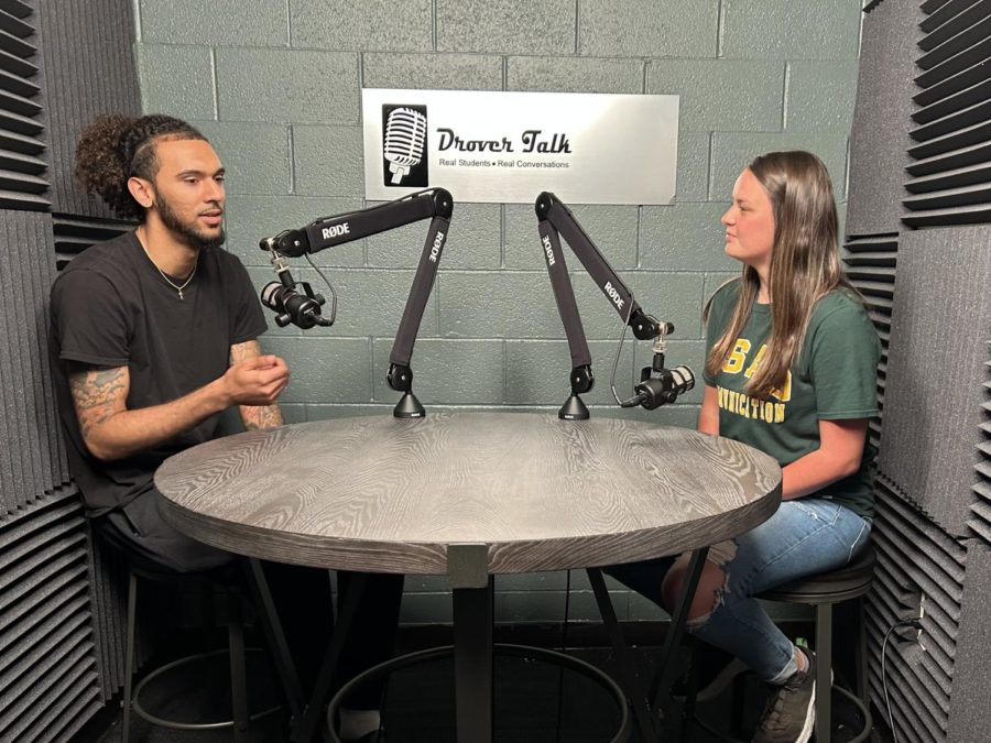 While filming an episode of Drover Talk, Tyler Cauley, a host, discusses journalism with his guest, Emily Loughridge. 