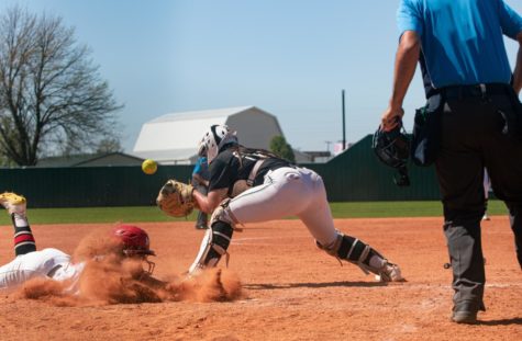 Tyler Trott almost has the ball in her glove so she can lay down the tag on an opposing baserunner at home.