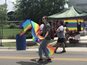 To showcase support for Pride Month, Bobbie Six twirls a flag rainbow down 39th. 
