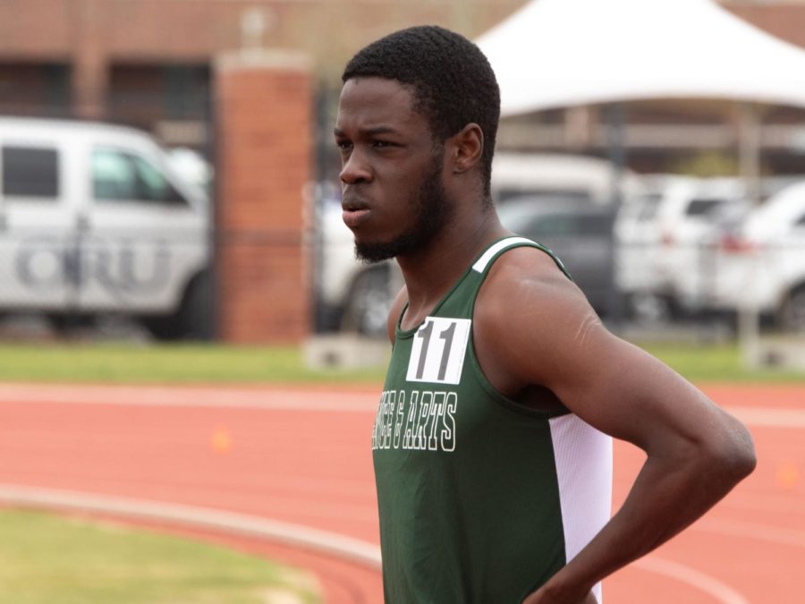 Kalique St. Jean releases a breath in anticipation as he waits to begin his next event during an outdoor meet. 