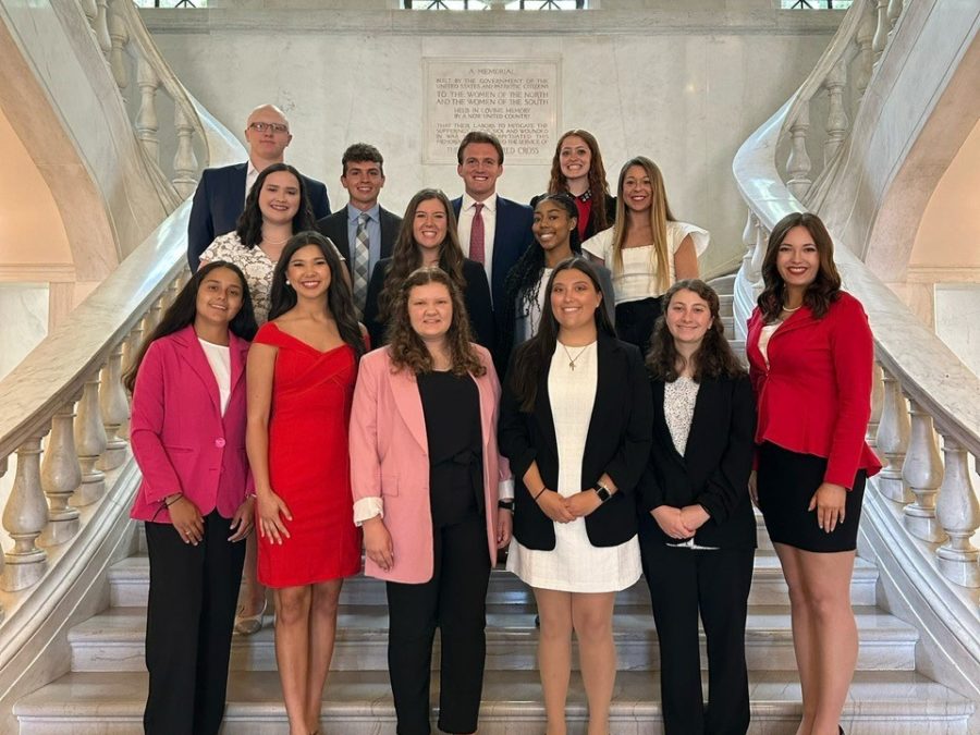 The Red Cross Collegiate Leadership Class of 2023 stands on the main steps of the Red Cross Headquarters. 