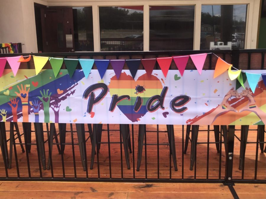 In an earlier parade this month, a banner hung to show its support of the LGBTQ+ community. 