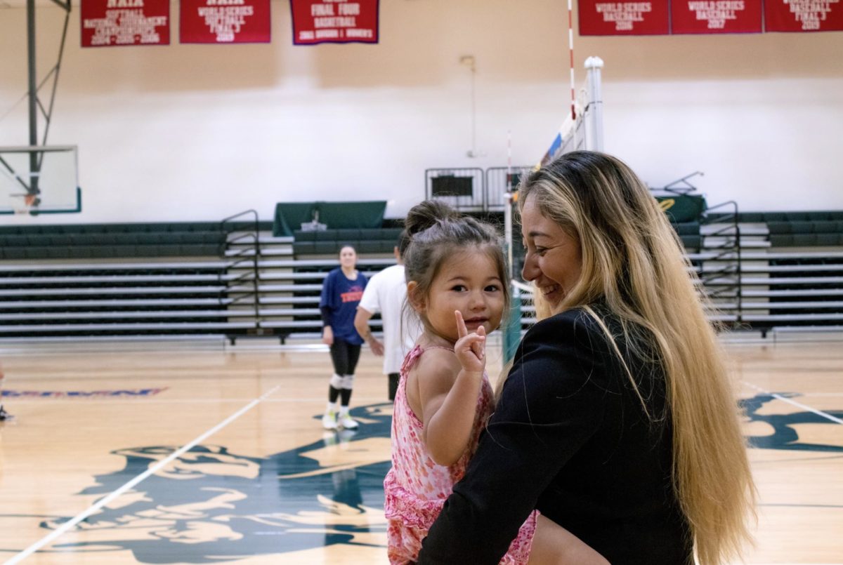 Coach Isabel Almendarez supervises a pre-season practice in the Drover Fieldhouse as her daughter, Esmee Bella Ramos makes a prediction of what the teams standing will be this season.