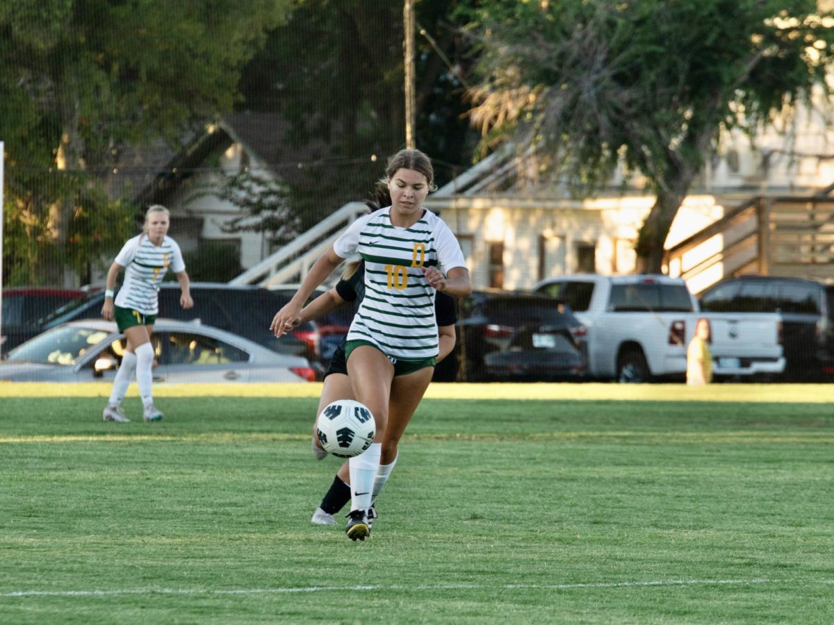 Avery Walker, a sophomore midfielder, keeps her eyes ahead on the goal, as she maneuvers the ball through her opponents. 