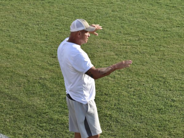 Jimmy Hampton, USAOs head mens soccer coach, directs his players from the sidelines during an intense match.