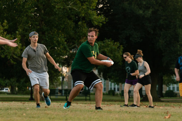 Gary Jackson, the Ultimate Frisbee Clubs vice president, looks to make a throw down field to score.