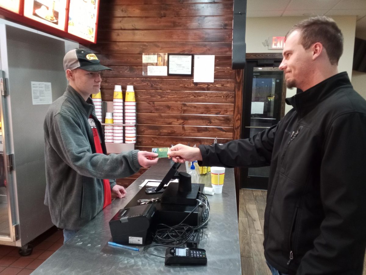 Gary Jackson uses his student ID to get a discount at the local Chicken Express in Chickasha. 