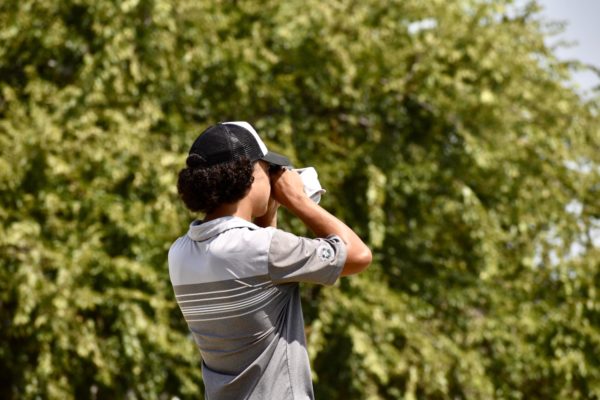 Jaeden Ellis uses his range finder at Winter Creek Golf Course earlier in the season. 