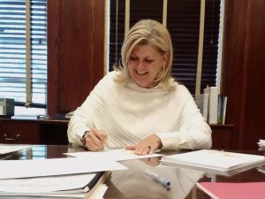 Dr. Hale signs awards for the Drover Awards, where she engaged with students and honored them for their achievements. 