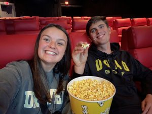 Emily Loughridge and Caleb Smith enjoy their popcorn before the movie begins in the Icon Theatre in OKC. 