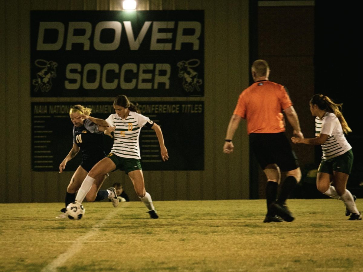 Kylie Strotman, a junior defender, battles in the SAC quarter-finals to pass the ball to her teammate. 