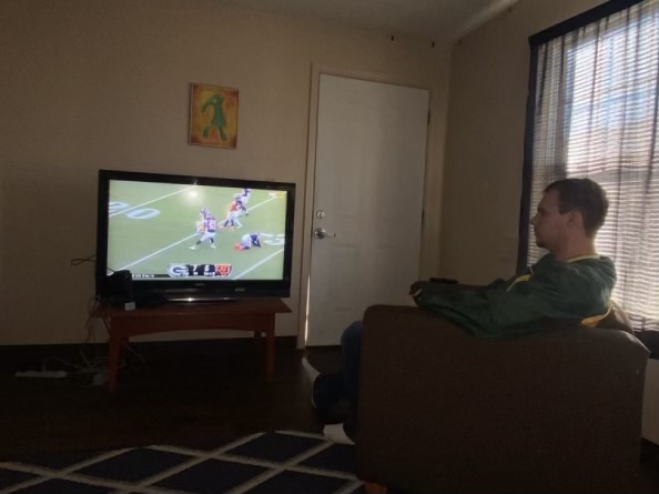Gary Jackson, a Green Bay Packers fan, watches an NFL game as he prepares to watch several of the games slated for this weekend. 