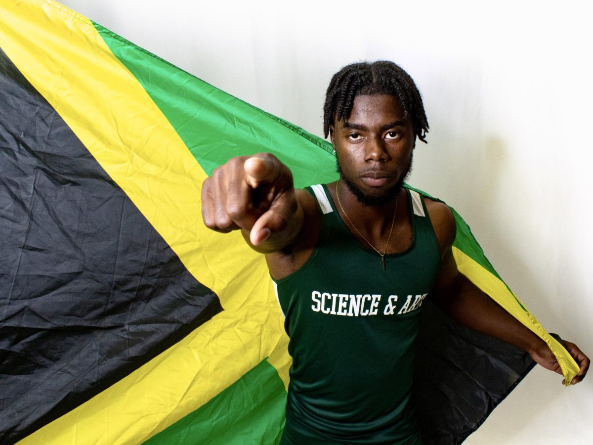 Sophomore Omario Johnson proudly waved his countrys flag during the teams media day.