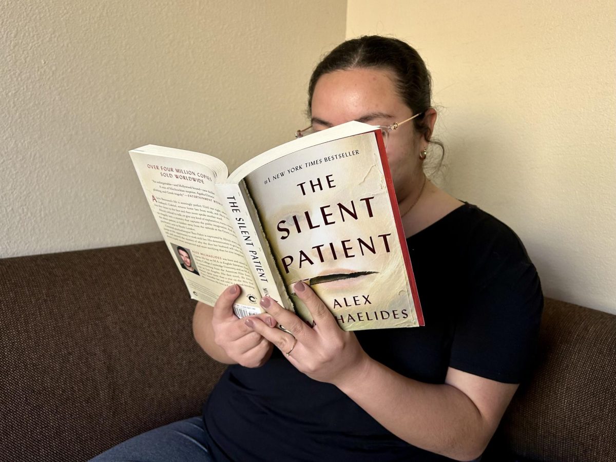 Kaelynn Torres sits in her apartment reading The Silent Patient as a break from her classes one afternoon. 