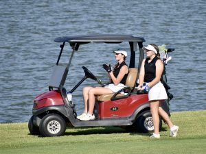 Moriah Shropshire (left) cheers on her teammate, Kiera Stehr, after she hit her ball towards the flag at Winter Creek Golf & Country Club.