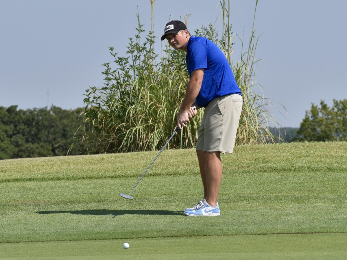 Sophomore Luca Gisler watches his putt roll towards the hole during a practice round in the fall. 
