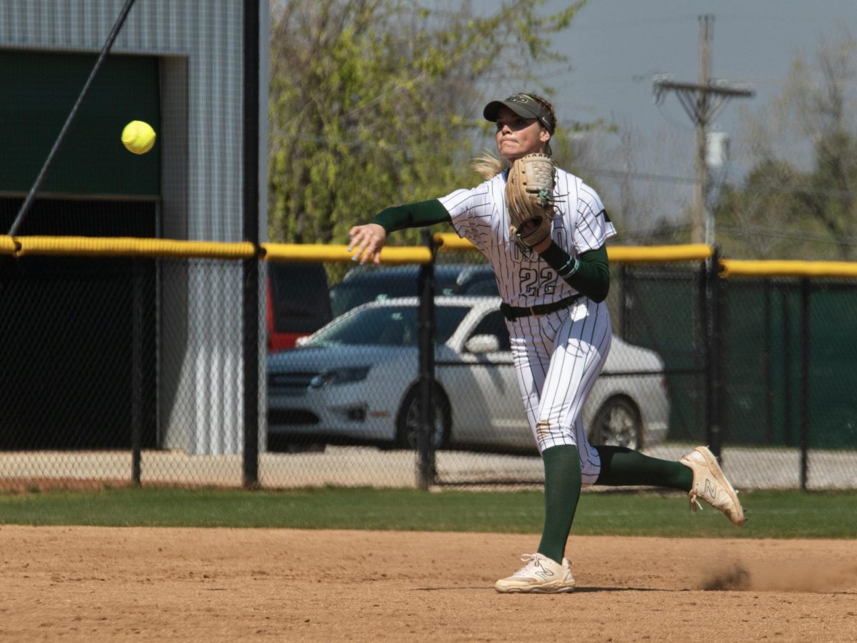 Shortstop Malea McMurtrey makes a throw across the infield to get a runner out at first. 