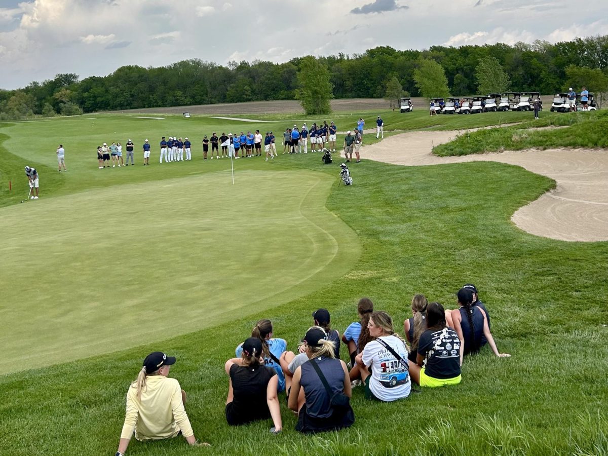 A large gallery of people watch as Caleb Smith and Chayan Duha play hole 10 for the title of individual champion. 