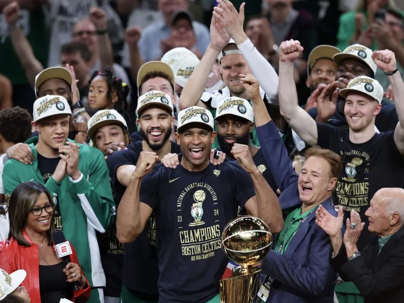 The Boston Celtics celebrate their record-breaking 18th win as a team.