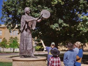 Jerrod shows his family around campus on sunny afternoon.