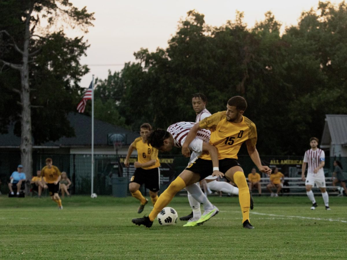 Stefan Savkovic fights against a Bethel competitor for the ball during a home game.