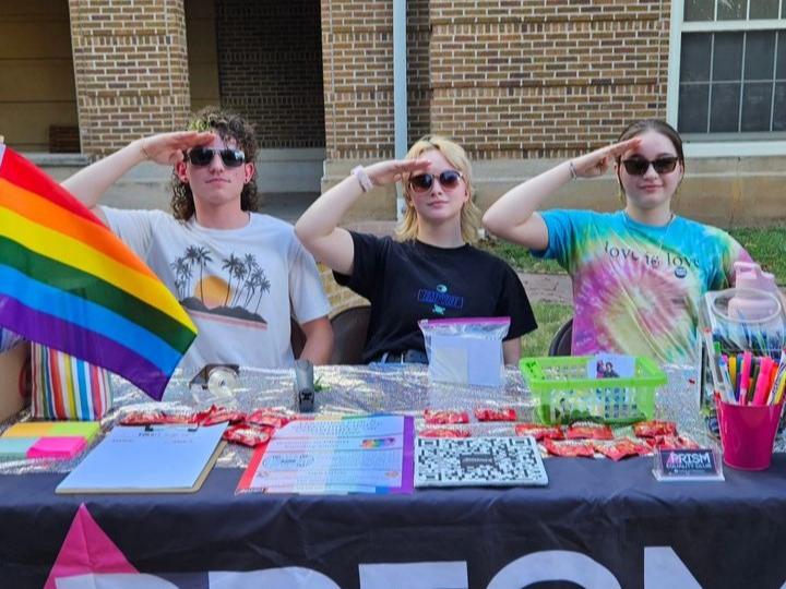 Co-President of PRISM Landon Cristal (left) and other members of PRISM salute for the photo. 