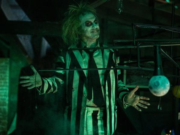 Beetlejuice (Michael Keaton) does his signature pose with his sinister look. 