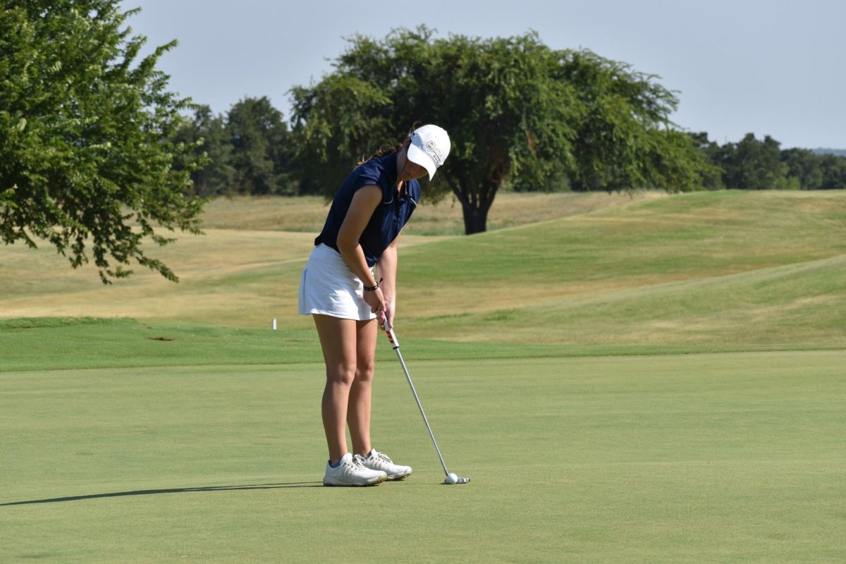 Hudson Woloss lines up a putt at Winter Creek Golf and Country Club.