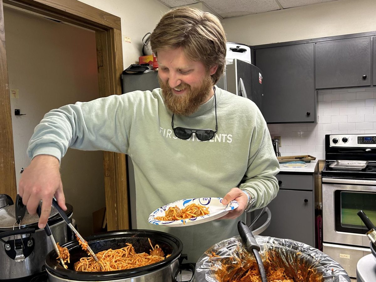 BCM Director Joe Quickle serves spaghetti and meatballs to students during a Noonday in mid-October.