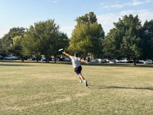 UFC President Gary Jackson reaches out to try and catch a frisbee. 