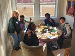 Multiple students with President Hale enjoying their meal during last year's Friendsgiving event. 